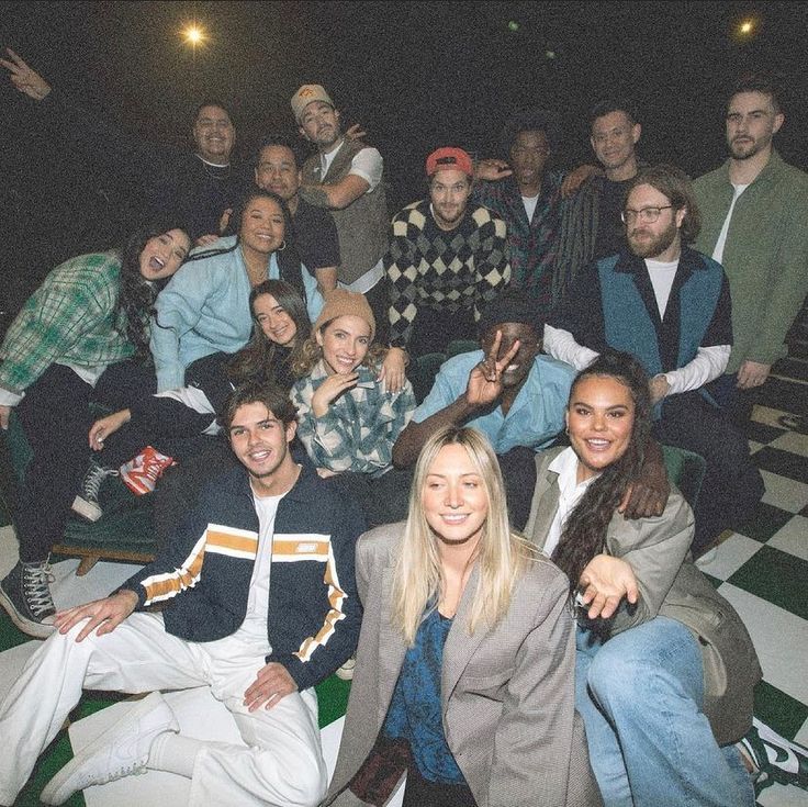 A group of friends piled together for a photo after a gathering